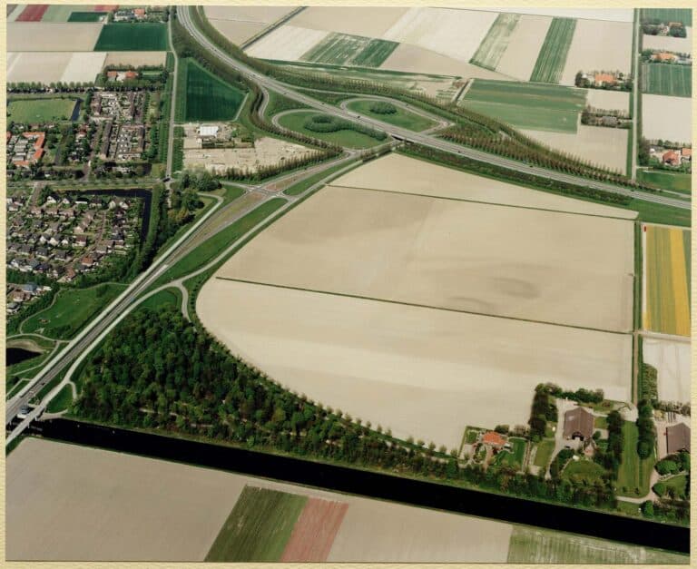 Middenmeer met op de voorgrond de Cultuurweg en op de achtergrond de A7 met de afslag naar Alkmaar en Middenmeer, op 30 april 1999. Bron: Regionaal Archief Alkmaar